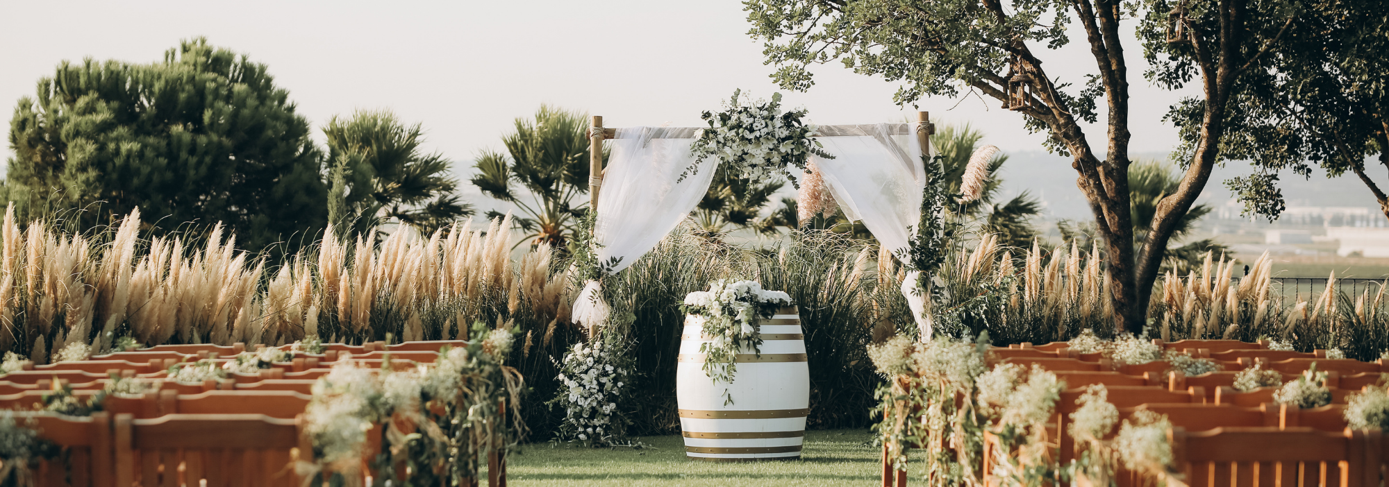 rustic outdoor wedding ceremony with white wash barrels 